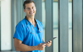 Cheerful,Young,Nurse,With,Tablet,Pc,In,Office