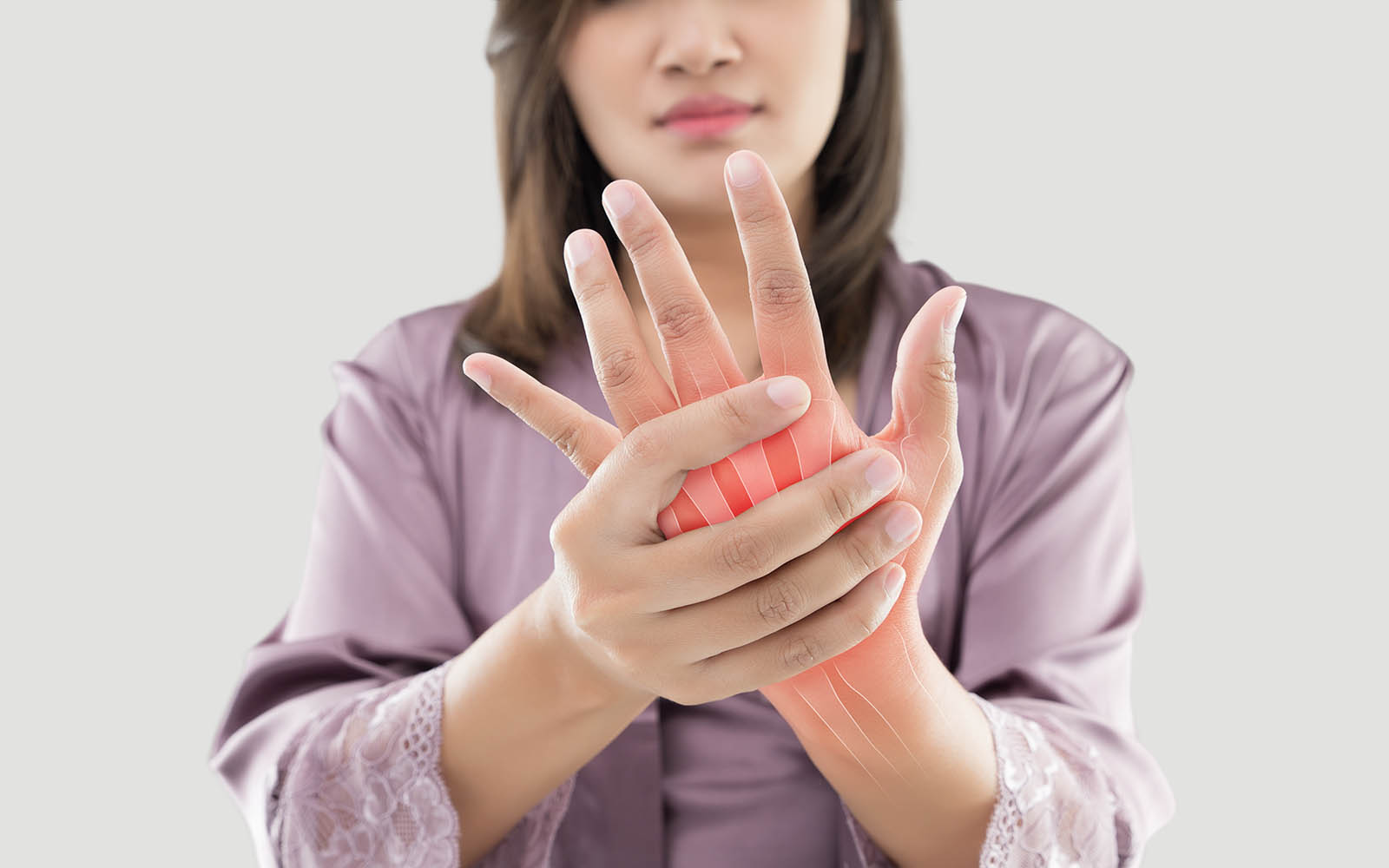 Asian,Woman,Suffering,From,Pain,In,Bone,Against,Gray,Background,