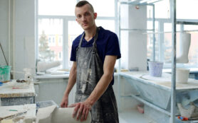 Contemporary,Young,Man,In,Apron,Looking,At,Camera,While,Standing