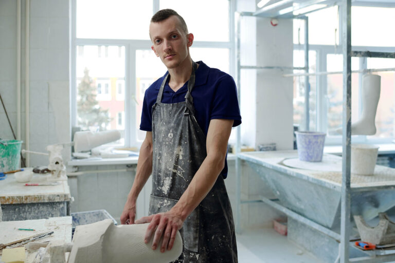 Contemporary,Young,Man,In,Apron,Looking,At,Camera,While,Standing