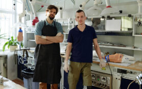 Two,Young,Specialists,In,Workwear,Standing,In,Large,Workshop,Of