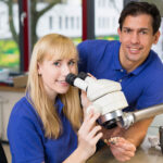 Apprentice,And,Dental,Technician,Look,At,Prosthesis,Under,A,Microscope