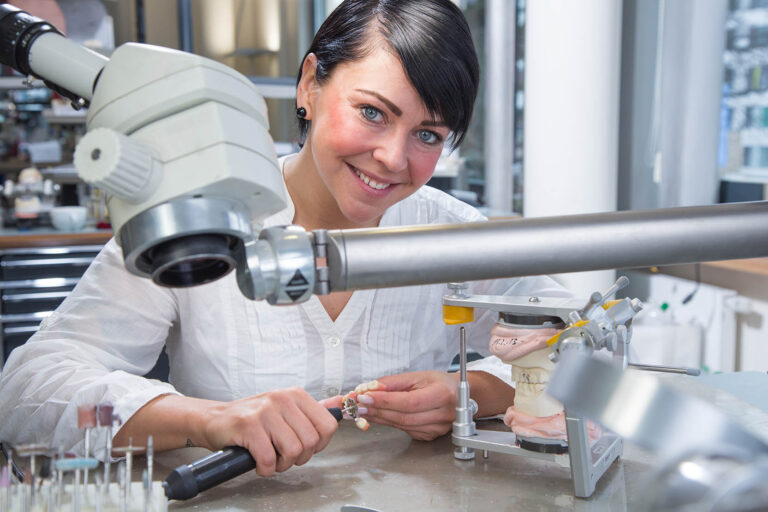 Technician,In,Dental,Lab,Working,Under,A,Microscope