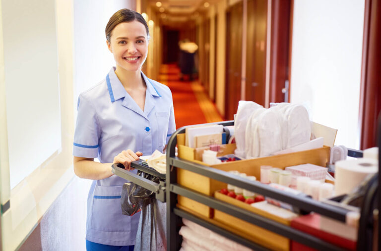 Young,Hotel,Staff,Bringing,Clean,Towels,And,Other,Supplies