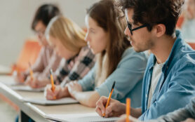 Row,Of,Multi,Ethnic,Students,In,The,Classroom,Taking,Exam/