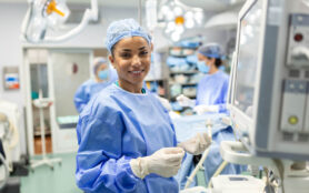 Anesthesiologist,Checking,Monitors,While,Sedating,Patient,Before,Surgical,Procedure,In