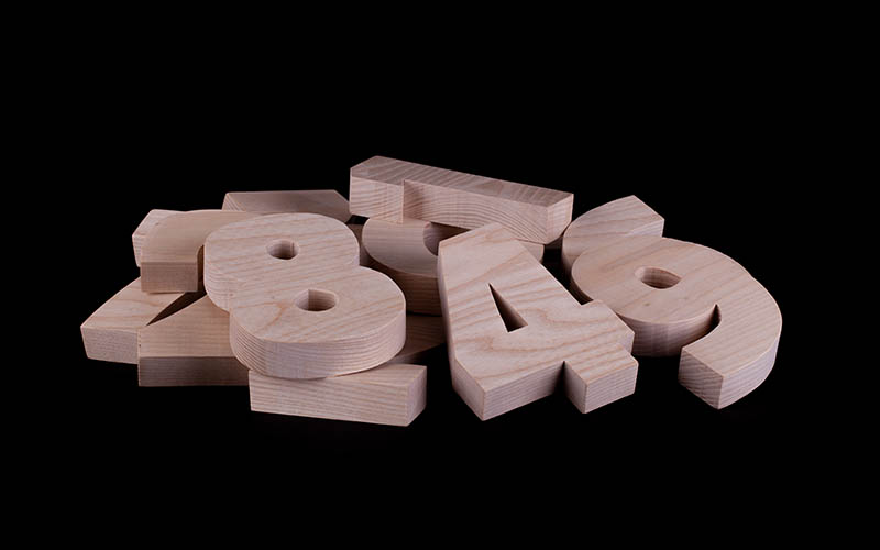 Pile,Of,Large,Random,Wooden,Numbers,With,A,Black,Background.