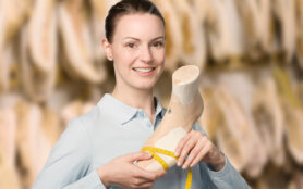 Young,Female,Orthopedic,Shoemaker,Holds,A,Handmade,Wooden,Last,In
