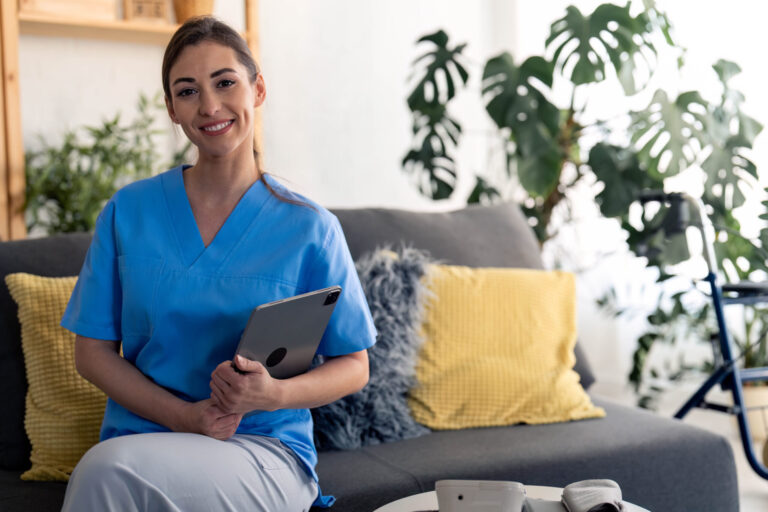 Young,Confident,Nurse,Looking,At,Camera,,Holding,Digital,Tablet,,Posing