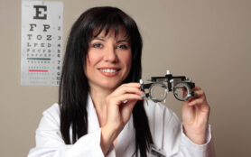 An,Eye,Doctor,Holding,A,Pair,Of,Eye,Test,Trial