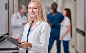 Pretty,Female,Doctor,In,White,Medical,Unifrom,With,Clipboard,In