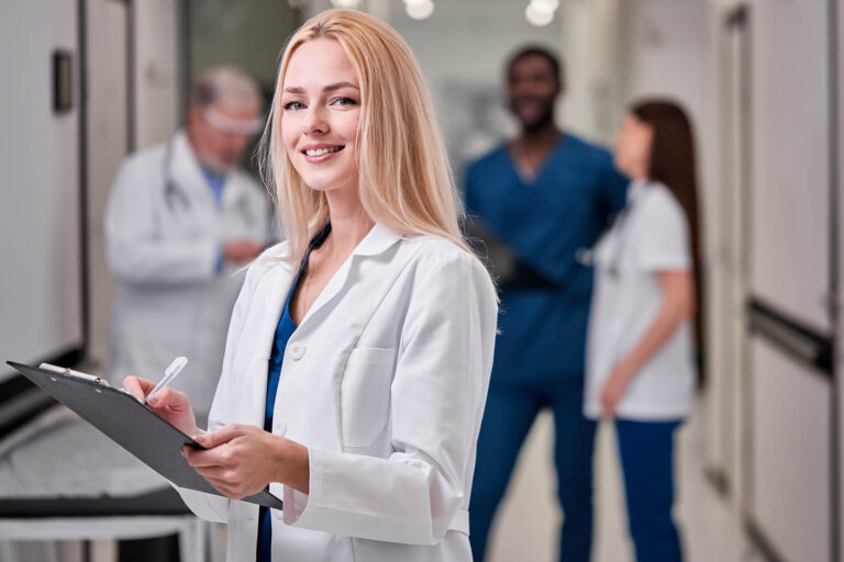 Pretty,Female,Doctor,In,White,Medical,Unifrom,With,Clipboard,In