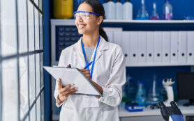 Young,African,American,Woman,Scientist,Write,On,Report,Document,At