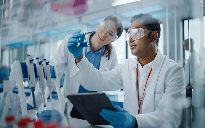 Modern,Medical,Research,Laboratory:,Two,Scientists,Working,Together,Analysing,Chemicals