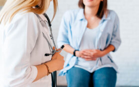 A,Woman,In,Consultation,With,A,Doctor,With,Abdominal,Pain.