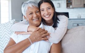 Hug,,Sofa,And,Portrait,Of,Women,Smile,For,Care,,Trust