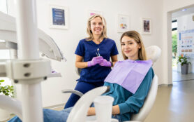Portrait,Of,Female,Dentist,With,Patient,In,Dental,Clinic.