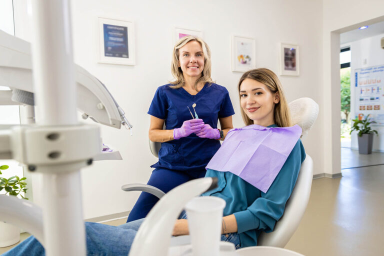 Portrait,Of,Female,Dentist,With,Patient,In,Dental,Clinic.