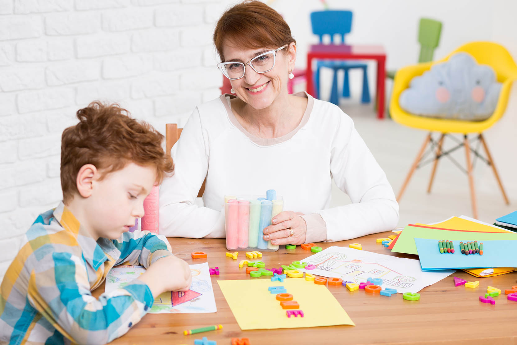 Smiling,Middle Aged,Woman,Sitting,At,A,Wooden,Table,Full,Of